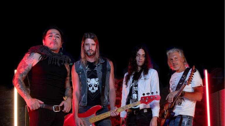 Disturbed band members rocking out in 2025